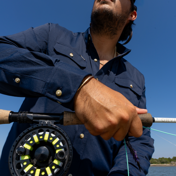 Man stripping out line from his fly reel
