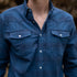 close-up of a blue button-up shirt with chest pockets from The Powder River collection