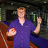 man wearing purple TCU shirt holding football