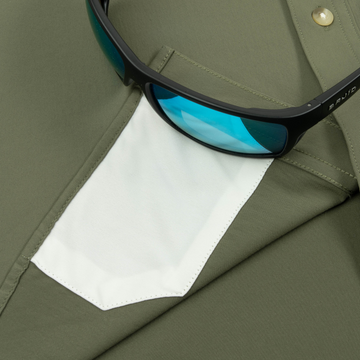 Closeup of sunglasses with lens cleaner on shirt