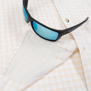 Closeup of sunglasses with lens cleaner on shirt
