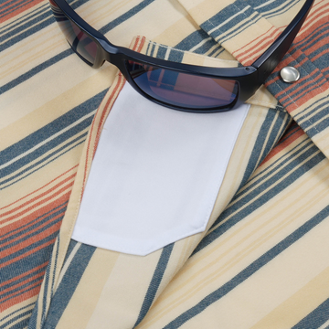 Close-up of striped fabric and sunglasses on The Saddle Blanket shirt pocket