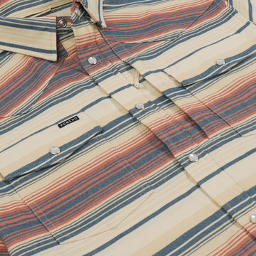 Close-up of striped button-up shirt fabric with snap buttons and a small Poncho label titled The Saddle Blanket