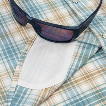 Closeup of sunglasses with lens cleaner on shirt