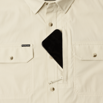 Phone in chest zipper pocket of shirt