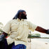 Man wearing Sawdust shirt while steering a boat