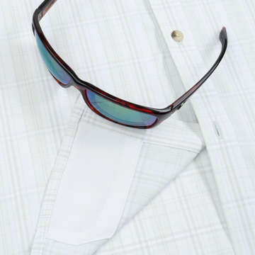 Closeup of sunglasses with lens cleaner on shirt