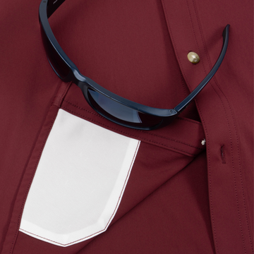 Closeup of sunglasses with lens cleaner on shirt