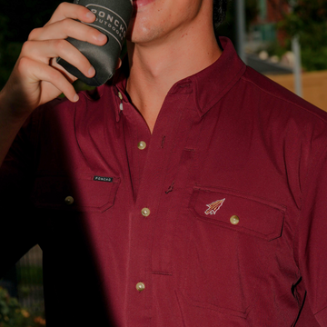 Close-up of a maroon shirt with logo details called The Seminole worn outdoors