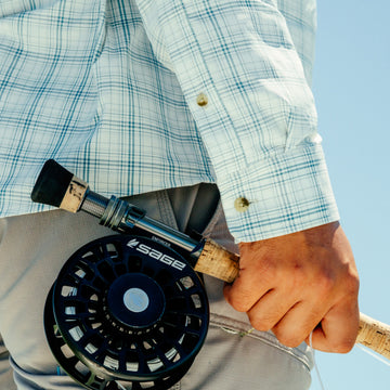 man holding fly rod wearing the silver king shirt
