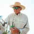 Man wearing The Soda Butte shirt and straw hat outdoors