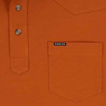 Close-up of the orange shirt pocket with buttons and a small Poncho label from The Speedway collection.