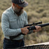 Man wearing The St. Helens shirt outdoors holding a rifle with scope