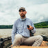 man driving boat wearing the steelhead shirt