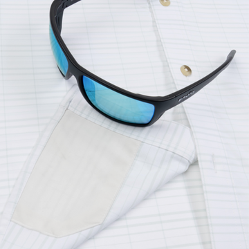 Closeup of sunglasses with lens cleaner on shirt