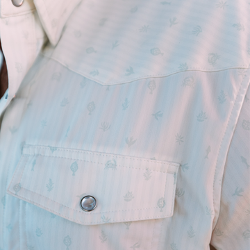 Close-up of The Surf No Turf outdoor shirt pocket with subtle tropical print and snap button closure