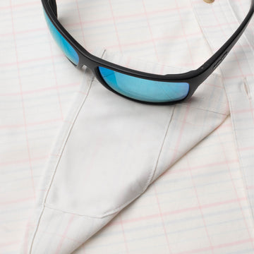 sunglasses with lens cleaner on shirt