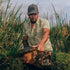 man holding large turtle wearing the swamp donkey shirt