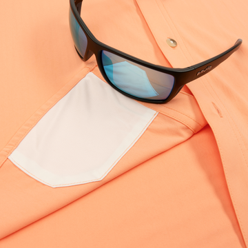 Closeup of sunglasses with lens cleaner on shirt