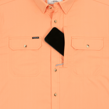 Phone in chest zipper pocket of shirt