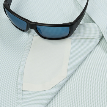 sunglasses with lens cleaner on shirt
