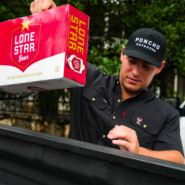 Man wearing The Tortilla shirt and Poncho Outdoors hat while unloading a box of Lone Star Beer outdoors