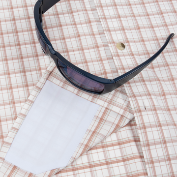 sunglasses with lens cleaner on shirt