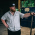 Man leaning while wearing The Wildcatter Shirt