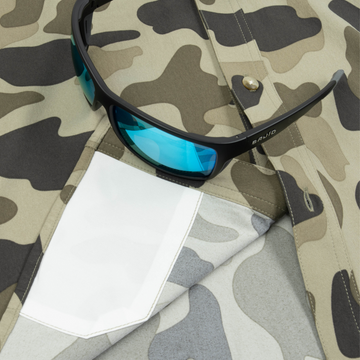 Closeup of sunglasses with lens cleaner on shirt