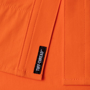 Close-up of orange fabric stitching detail with black Tuff-Thread label on The Dick Cheney shirt