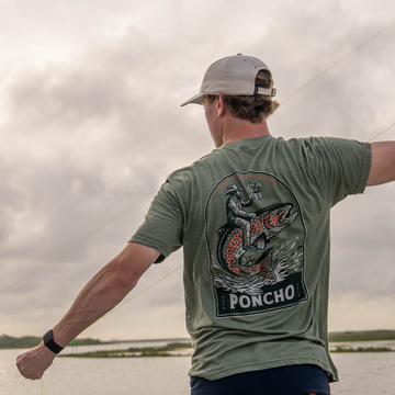 Man Fly fishing while wearing The Trout Rider T-Shirt