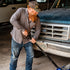 Man jacking up a truck to fix the tire