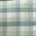 Close-up of light green and white plaid fabric with stitching detail