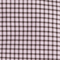 Close-up of light pink fabric with small dark checkered pattern