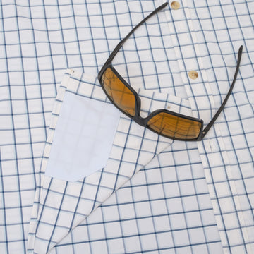 Sunglasses on hidden fabric cleaner of blue plaid shirt