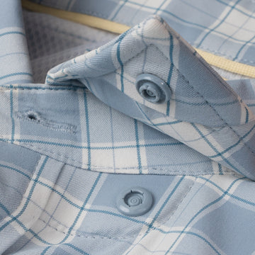 Close up of hidden snap collar on blue plaid button down shirt